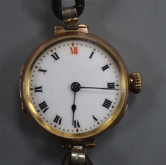 A vintage 9ct gold-cased ladys wristwatch on leather strap, white enamelled Roman dial
